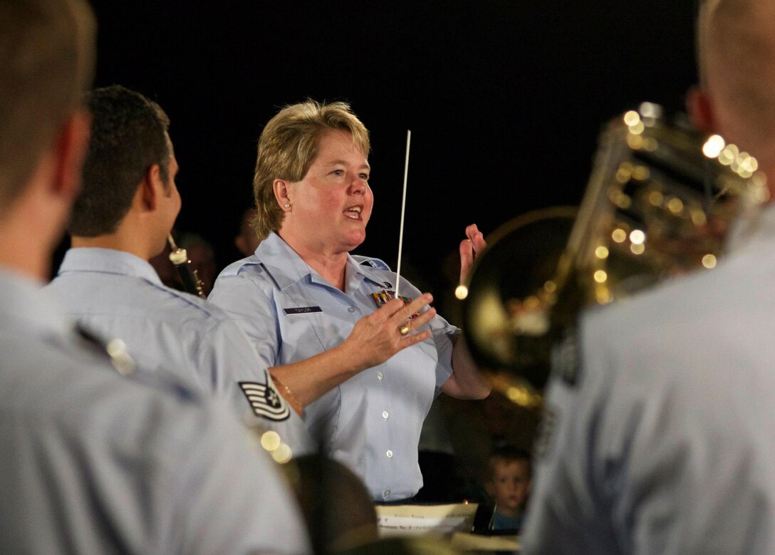 Chief Master Sgt. Barbara Taylor conducts the Concert Band at the Air Force Memorial for her final concert with The U.S. Air Force Band. (AF photo by Senior Master Sgt. Kevin Burns)