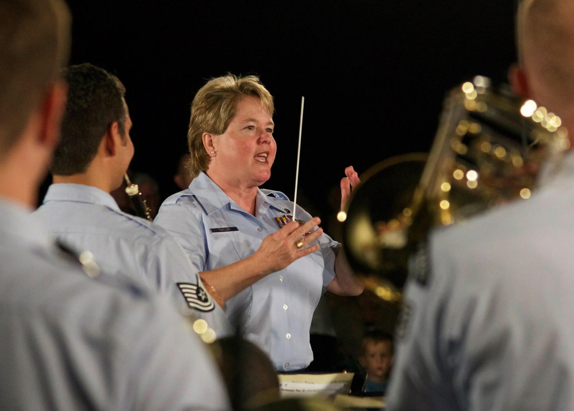 Chief Master Sgt. Barbara Taylor conducts the Concert Band at the Air Force Memorial for her final concert with The U.S. Air Force Band. (AF photo by Senior Master Sgt. Kevin Burns)