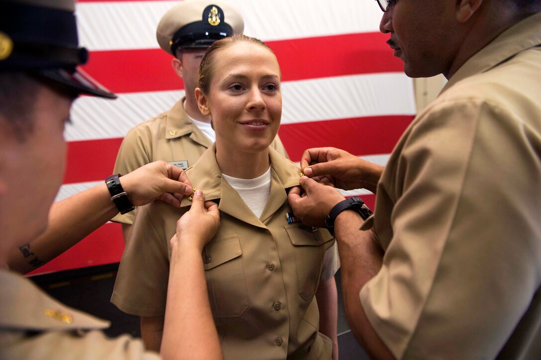 U.S. Navy Chief Petty Officer Doris Koch is pinned during a chief's pinning ceremony in the hangar bay aboard the Nimitz-class aircraft carrier USS John C. Stennis under way in the Pacific Ocean, Sept. 14, 2012. Koch is a personnel specialist.