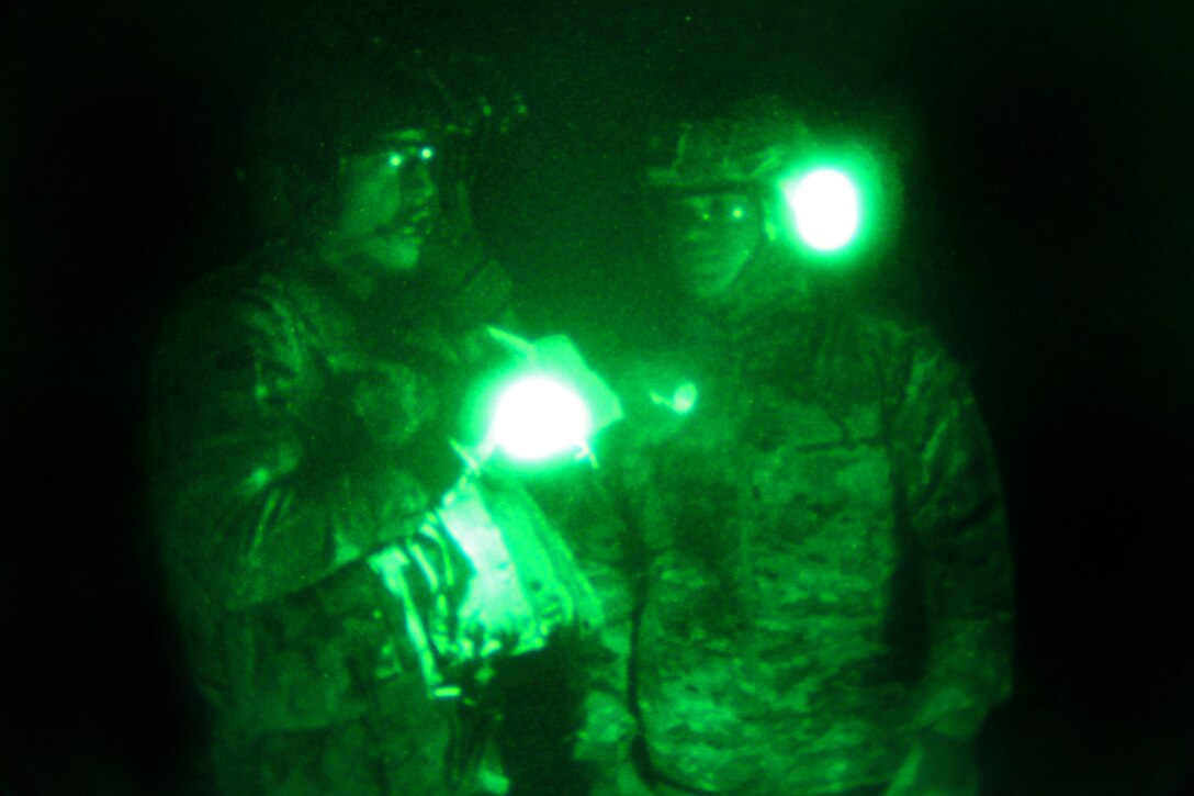 As seen through a night-vision device, U.S. soldiers prepare for sling ...