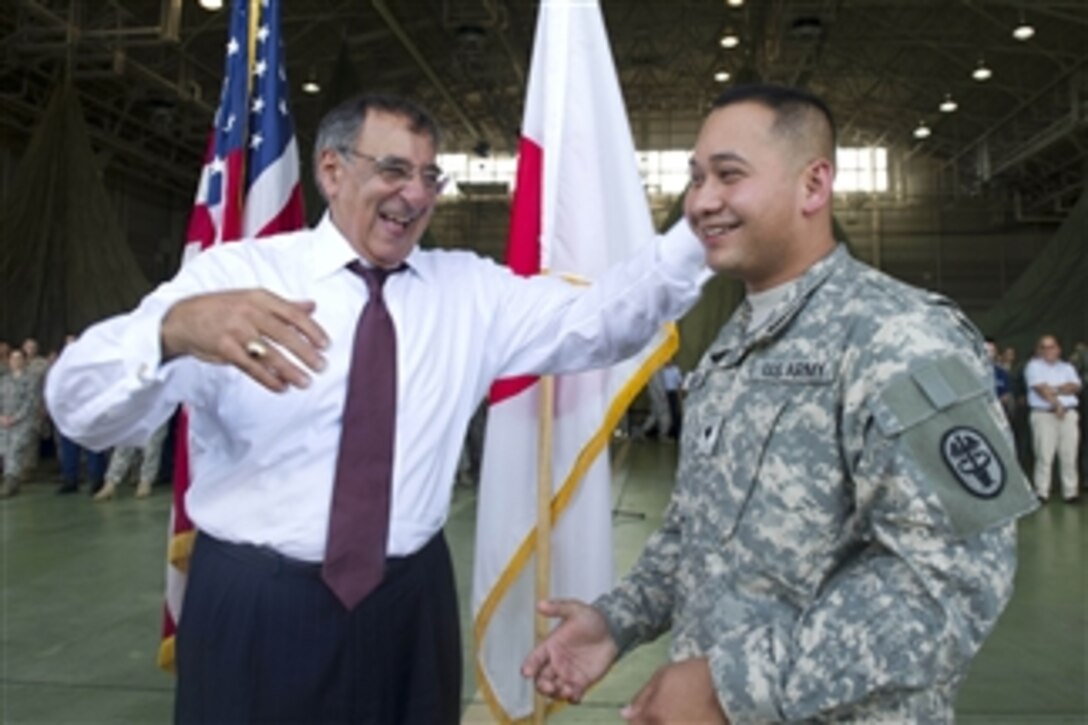 Secretary of Defense Leon E. Panetta, left, laughs with a U.S. Army soldier while visiting service members at Yokota Air Base in Tokyo, Japan, on Sept. 17, 2012.  Panetta will also visit with defense counterparts in Tokyo before traveling to Beijing, China, and Auckland, New Zealand, on a weeklong trip to the Pacific.  