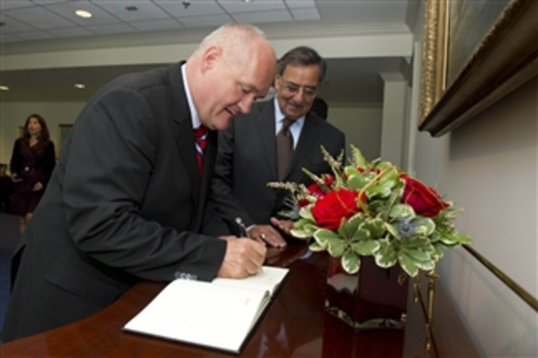 Secretary of Defense Leon E. Panetta, right, watches as Hungarian Minister of Defense Csaba Hende signs the guest book prior to a meeting in the Pentagon on Sept. 14, 2012.  Panetta and Hende are meeting to discuss national security items of interest to both nations.  