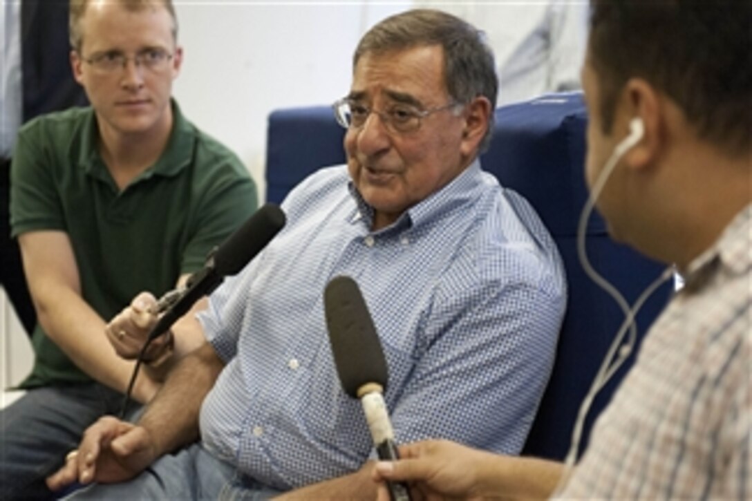 Secretary of Defense Leon E. Panetta, center, briefs the traveling press pool during a flight to Tokyo, Japan, on Sept. 15, 2012.  Panetta will visit with defense counterparts in Tokyo before traveling to Beijing, China, and Auckland, New Zealand, on a weeklong trip to the Pacific.  