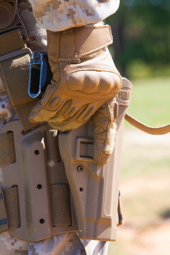 Lance Cpl. Jarod A. Carroll, Orlando, Fla. native, chemical, biological, radiological and nuclear defense specialist, 26th Marine Expeditionary Unit (MEU), reaches for his M9 Beretta pistol during combat pistol marksmanship training at Fort Pickett, Va., Sept. 13, 2012. The training focused on the fundamentals of drawing, assessing and firing at a paper target while wearing a full combat load. This training is part of the 26th MEU's pre-deployment training program. The 26th MEU is slated to deploy in 2013.