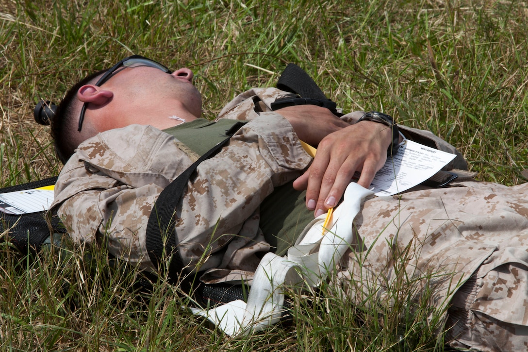 A simulated casualty lies awaiting a litter during a mass casualty training exercise at Fort Pickett, Va., Sept. 14, 2012. A mass casualty is defined as any number of casualties produced in a relatively short period of time that overwhelms the emergency medical services and logistical support. This training is part of the 26th MEU's pre-deployment training program. CLB-26 is one of the three reinforcements of 26th MEU, which is slated to deploy in 2013.
