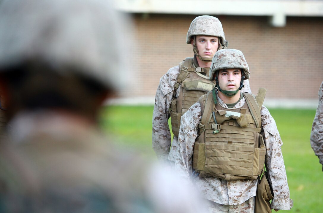Marines with Headquarters Company, Combat Logistics Regiment 27, 2nd Marines Logistics Group stand at attention after a six-mile hike aboard Camp Lejeune, N.C., Sept. 13, 2012. The company used the hike to test its Marines’ and sailors’ endurance, along with their mental and physical strength. 