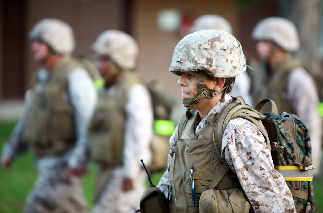 First Sgt. Brenda R. Chrismer, the first sergeant for Headquarters Company, Combat Logistics Regiment 27, marches next to the formation during a hike aboard Camp Lejeune, N.C., Sept. 13, 2012. Marines and sailors were put to the test physically and mentally during a six-mile trek through the French Creek area of the base.