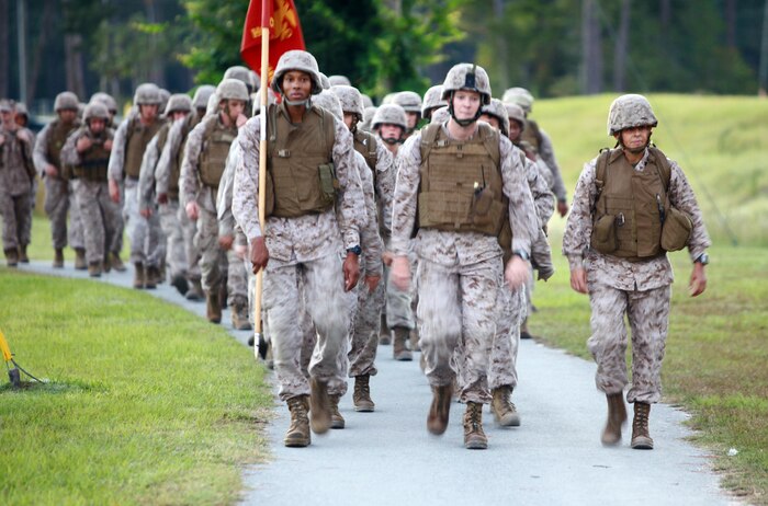 Capt. James S. Mackin, the commanding officer for Headquarters Company, Combat Logistics Regiment 27, leads the Marines and sailors of the company during a hike aboard Camp Lejeune, N.C., Sept. 13, 2012. The troops were put to the test physically and mentally during a six-mile trek through the French Creek area of the base.