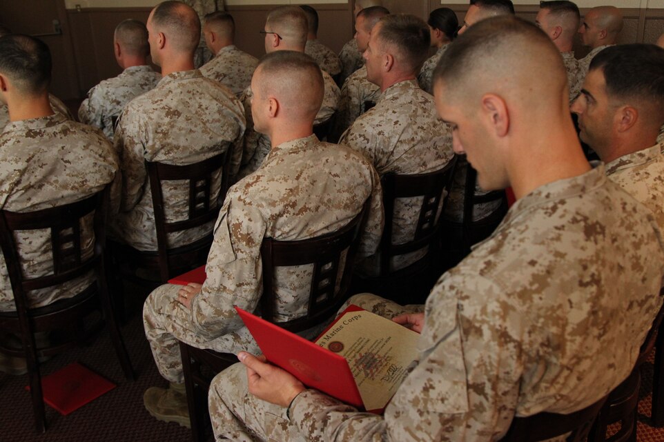 Capt. Kyle Opel, student, Intermediate Marine Air Ground Task Force Logistics Operations Course 4-12, looks at his completion certificate during the class’ graduation ceremony at the Combat Centers’ Officer’s Club Aug 31, 2012.