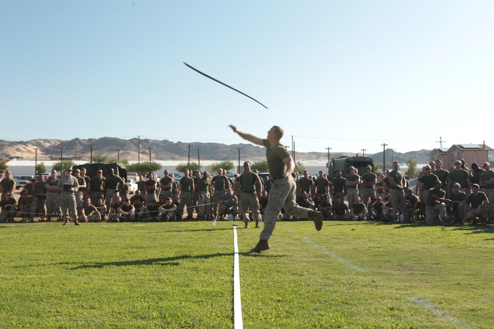 Cpl. John Stewie, mechanic, 1st Tank Battalion, throws the 42-pound Tank Bar in the Tank Bar Toss during the unit’s field meet at Del Valle Field Aug. 31, 2012.