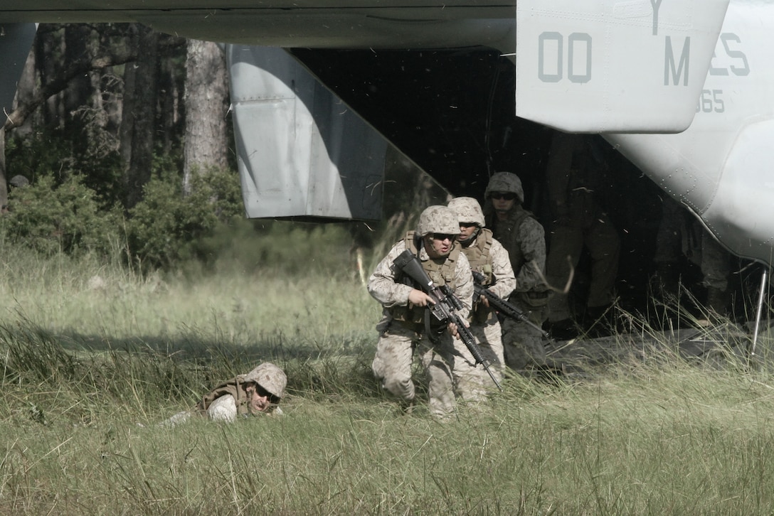 MARINE CORPS BASE CAMP LEJUENE, N.C. – Marines from Headquarters Company, 8th Marine Regiment, 2nd Marine Division exit an MV-22 Osprey after a simulated casualty evacuation Sept. 12 during a regimental field exercise aboard Marine Corps Base Camp Lejeune.(U.S. Marine Corps photo by Sgt. Steve Cushman)