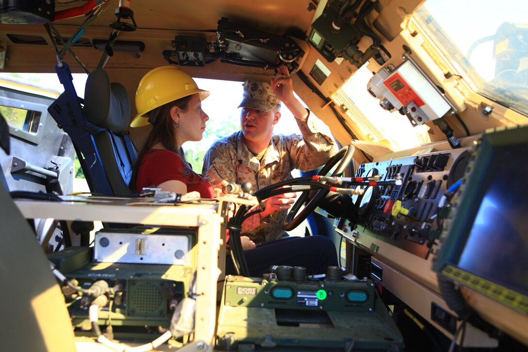 Cpl. Tyler Rickert, a motor vehicle mechanic with Combat Logistics Battalion 6, 2nd Marine Logistics Group, runs through the controls for a Mine Resistant Ambush Protected – All-Terrain Vehicle for his wife, Alicia Rickert, during the unit’s Jane Wayne Day activities aboard Camp Lejeune, N.C., Sept. 12, 2012. The event’s activities were designed to demonstrate what a day in the life of a Marine is like for their family members.