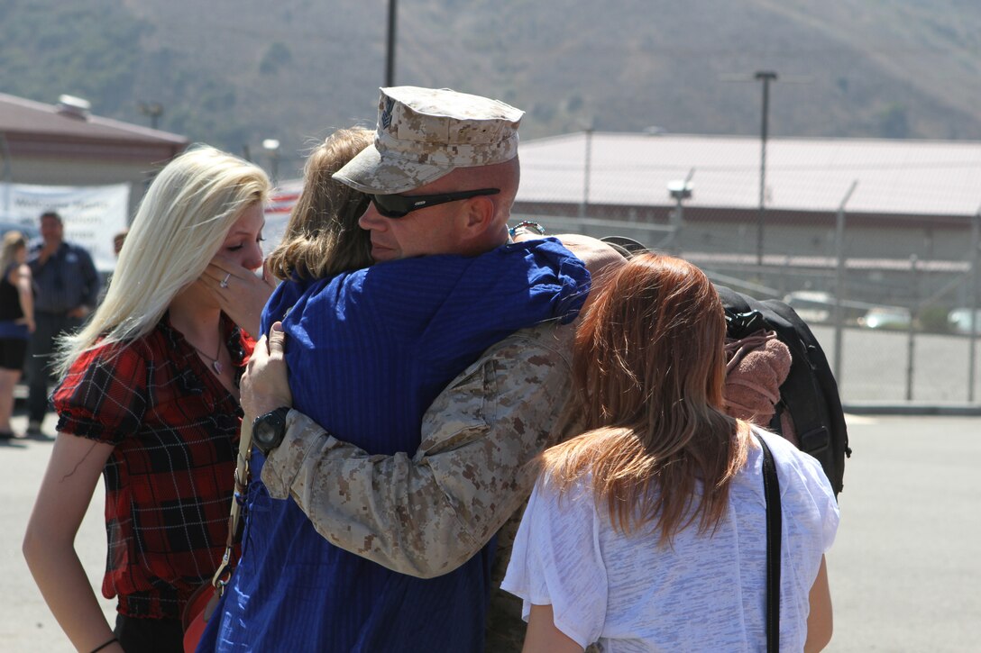 Petty Officer 1st Class Nathan Hardin, an independent duty corpsman serving with 2nd Battalion, 5th Marine Regiment, reunites with his family after returning home Sept. 17, 2012, from a deployment to Afghanistan. Hardin, an Escondido, Calif., native, treated Marines at the battalion aid station, a medical component within 2nd Bn., 5th Marines? Headquarters and Service Company. More than 1,100 Marines and sailors serving with the battalion returned from a seven-month deployment to northern Helmand province, Afghanistan.