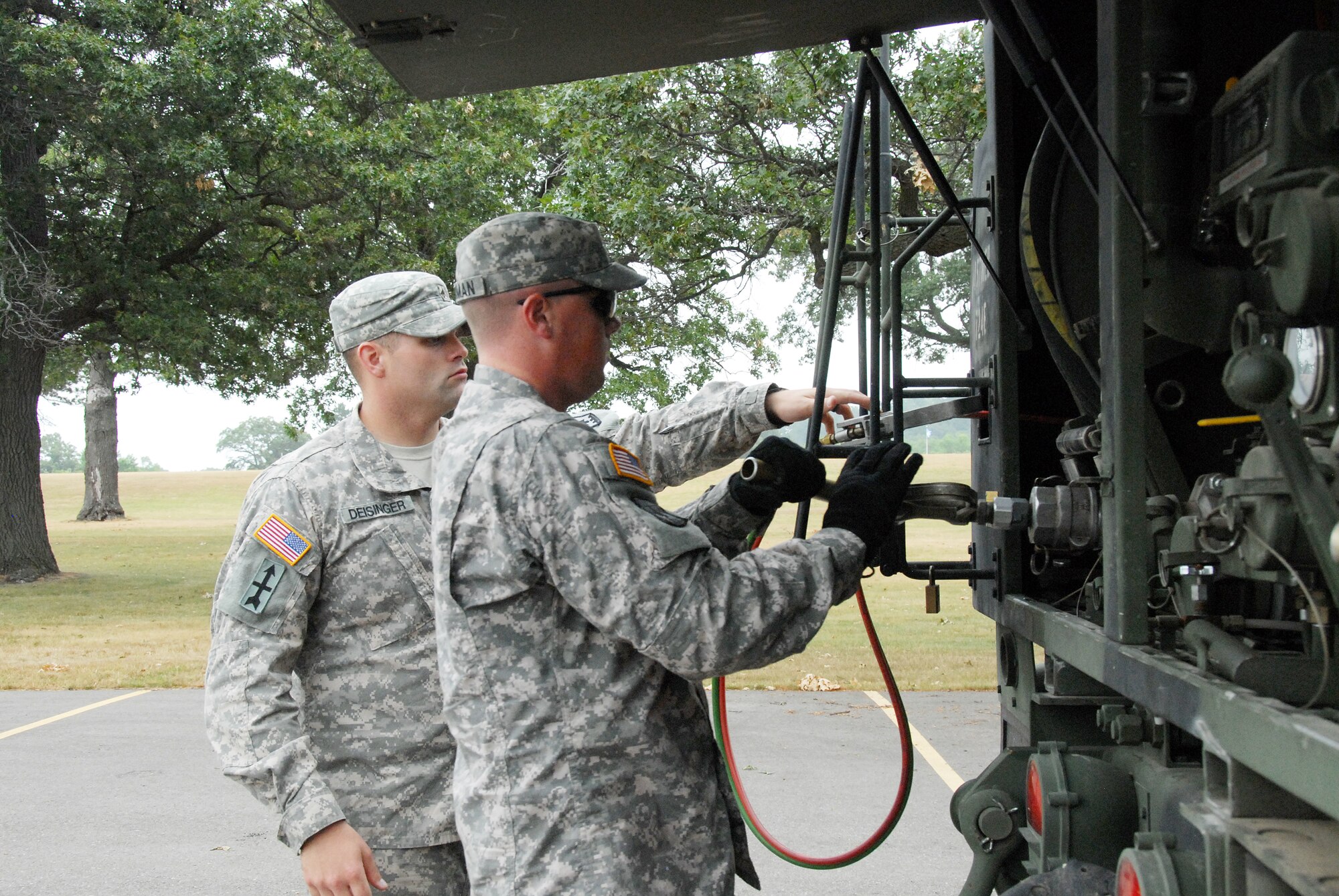 Sgt. Joshua Deisinger and Sgt. David Herman, 724th Engineer Batallion, complete operations after refueling a vehicle during PATRIOT 12. The refueling section of Company A, 724th Engineer Battalion of Hayward conducted round-the-clock refueling missions, supporting the whole PATRIOT 12 exercise, for equipment used during the exercise. The operation was part of PATRIOT 12, a National Guard domestic response exercise that included both military and civilian agencies. Wisconsin National Guard photo by Sgt. Robert Waight