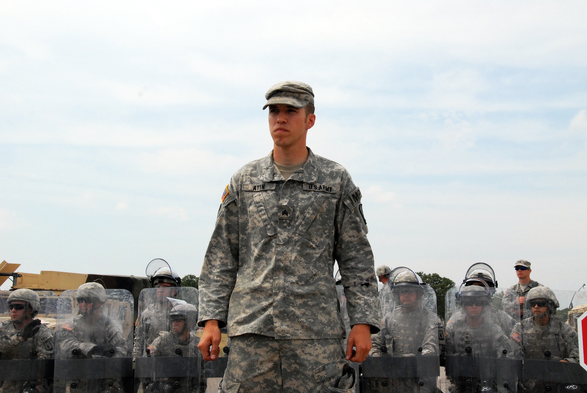 Sgt. Eugene Aten, of the Wisconsin Army National Guard's 32nd Military Police Company, approaches a group of evacuated local residents making their way toward a traffic control point. The scenario was part of PATRIOT 12, a National Guard domestic response exercise that included both military and civilian agencies. Wisconsin National Guard photo by Sgt. Robert Waight 