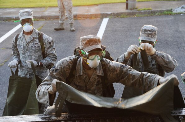 Members of the 35th Force Support Squadron search and recovery team lift simulated body bags onto a truck for transport during an emergency management exercise at Misawa Air Base, Japan, Sept. 17, 2012. Bodies are transported to morgues and identified for proper burial. (U.S. Air Force photo by Airman 1st Class Kenna Jackson/Released)
