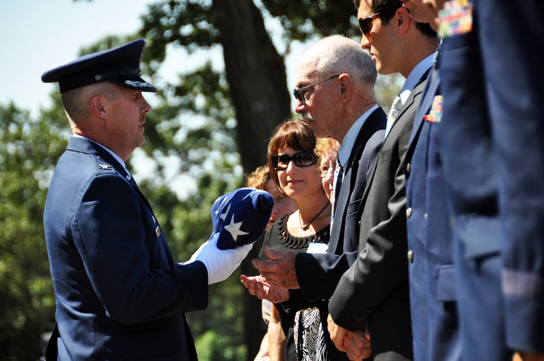 Col. Gary Ebben, Volk Field commander, presents Don Volk with a folded flag following a July 11 memorial service for 1st Lt. Jerome Volk, the first Wisconsin Air National Guard pilot to die in the line of duty during the Korean conflict. Volk was shot down during a combat sortie against communist forces Nov. 7, 1951, and his remains have never been recovered. In 1957 the Wisconsin legislature renamed the portion of Camp Williams used by the Wisconsin Air National Guard as Volk Field. Don Volk, 1st Lt. Volk's younger brother and next of kin, and dozens of other relatives attended the ceremony, which included full military honors such as a color guard, rifle squad, and a "missing-man formation" F-16 fly-over. Wisconsin National Guard photo by 1st Sgt. Vaughn R. Larson