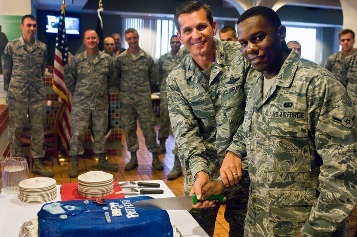 Col. Barry Cornish, 99th Air Base Wing commander and Airman Andreas Morgan, 99th Force Support Squadron food services apprentice, cut a cake Sept. 18, 2012 at the Cross Winds Dining Facility on Nellis Air Force Base, Nev. Airmen joined together at the Crosswinds Dining Facility to celebrate the United States Air Force's 65th birthday where a special made lunch was served by the youngest and most senior Airmen. (U.S. Air Force photo by Senior Airman Jack Sanders)

