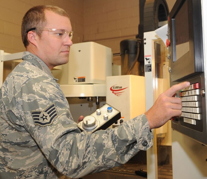 Staff Sgt. David Cordes, 2nd Maintenance Squadron aircraft metals technology craftsman, uses a hand jog to manually move the quill and table on a computer numerical control mill on Barksdale Air Force Base, La., Sept. 18. Usually automated, the mill can also be controlled by hand to create aircraft brackets, test fixtures and anything else need to support the aircraft. (U.S. Air Force photo/Senior Airman Kristin High)(RELEASED)