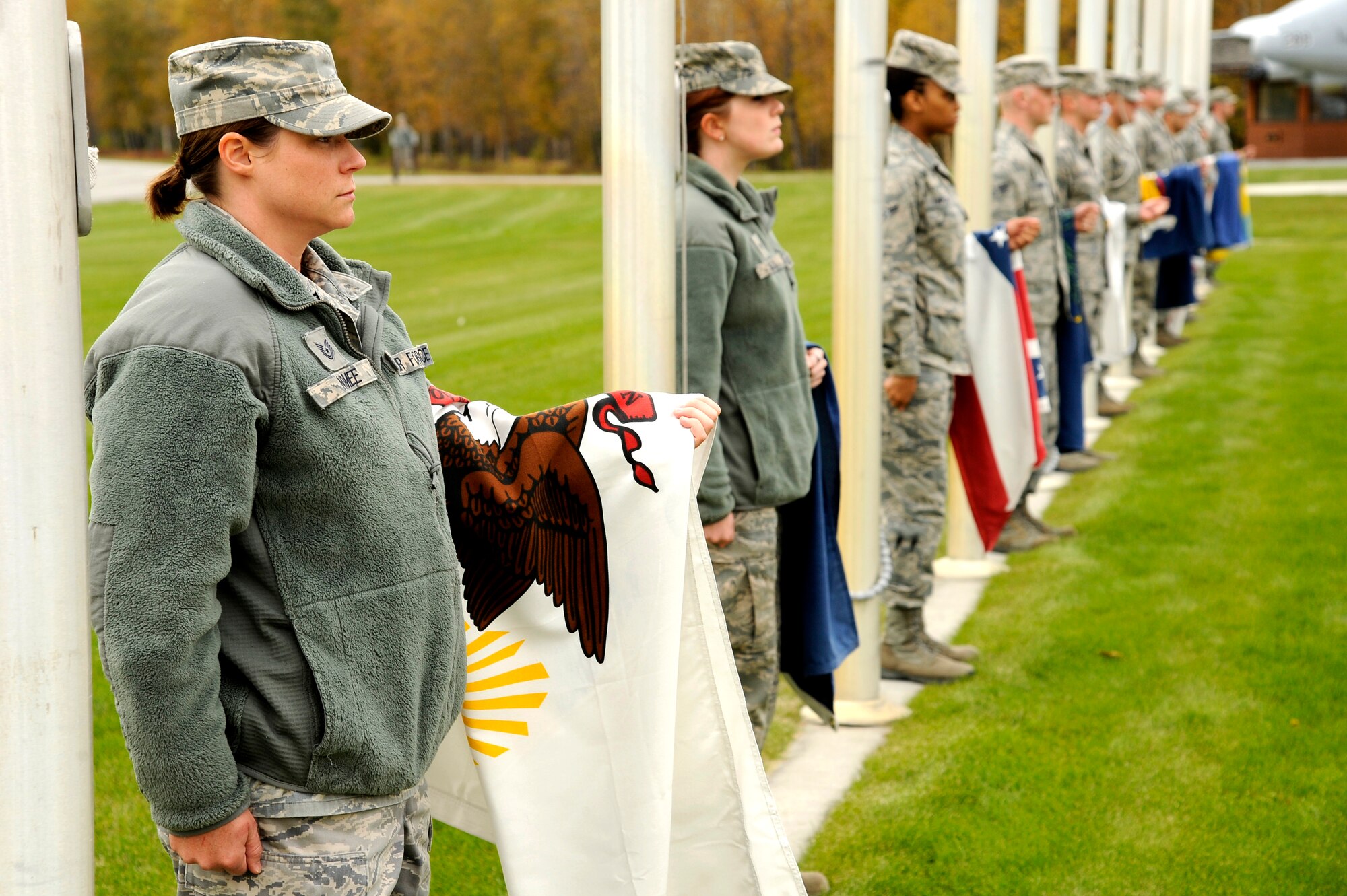 Members of Eielson Air Force Base lower the state flags during the prisoner of war/missing in action retreat ceremony Sept. 14, 2012, Eielson AFB, Alaska. The lowering of the state flags also closes Heritage Park for the upcoming winter season. (U.S. Air Force photo/Staff Sgt. Jim Araos)