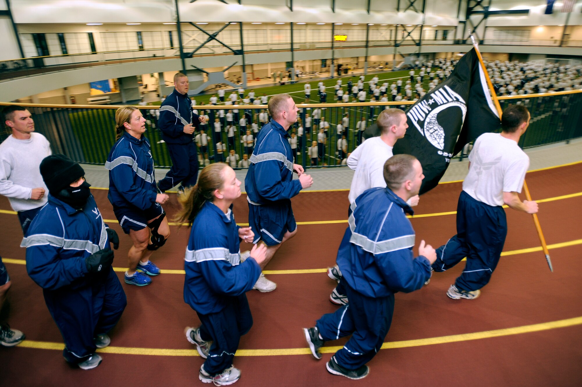 Members of Eielson Air Force Base run through Baker Field House during the prisoner of war/missing in action remembrance run Sept. 14, 2012, Eielson AFB, Alaska. The run aimed to support and show the appreciation to the sacrifices POWs endured and those MIA still endure. (U.S. Air Force photo/Staff Sgt. Jim Araos)