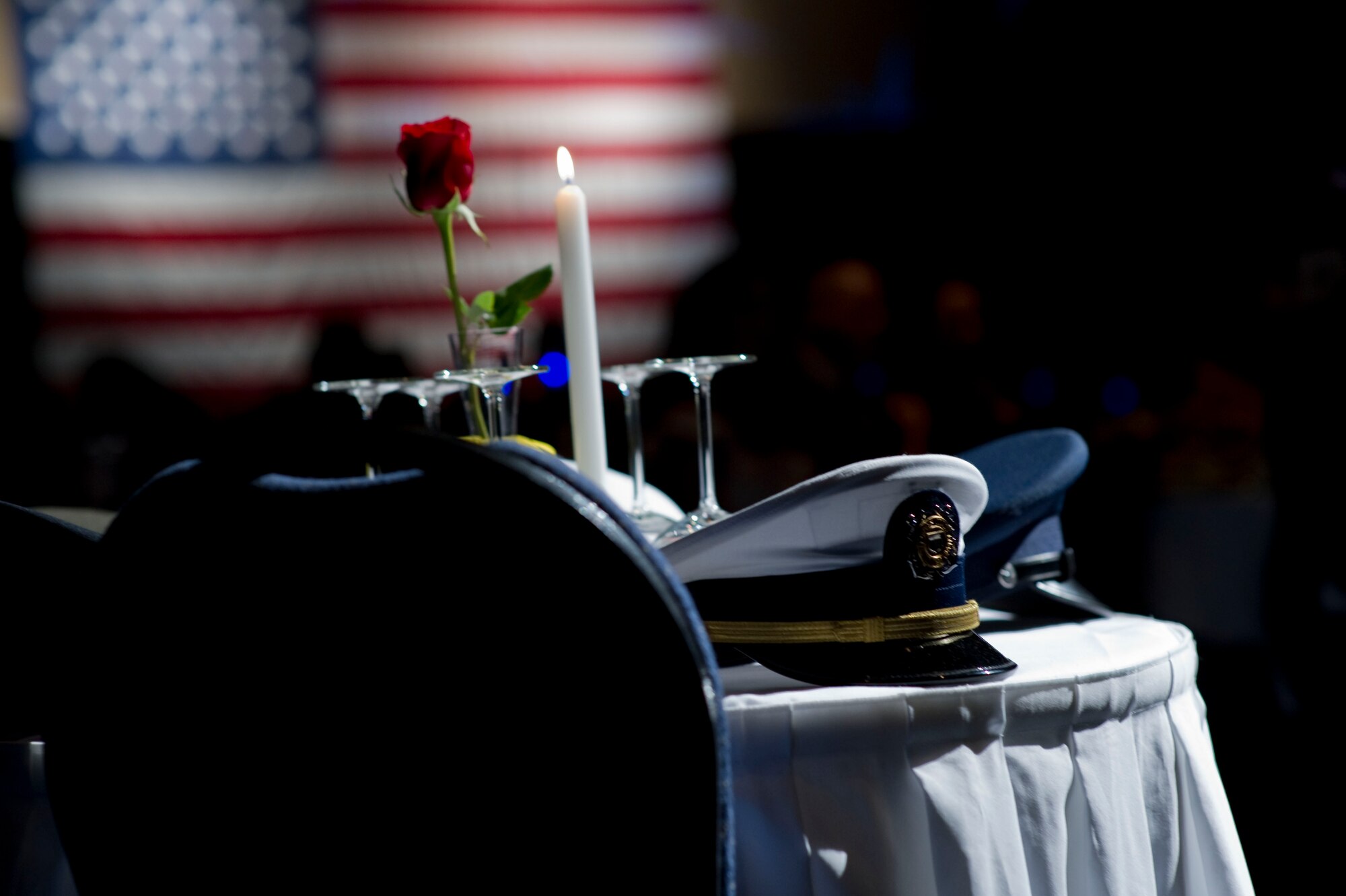 The service caps of the U.S. Army, Marine Corps, Navy, Air Force and Coast Guard rest on a Prisoner of War/Missing in Action table during the inaugural Hurlburt Ball at the Emerald Coast Conference Center on Okaloosa Island, Fla., Sept. 14, 2012. The ball honored the contributions of all service members who are still lost or missing in action. (U.S. Air Force photo / Tech. Sgt. Vanessa Valentine)