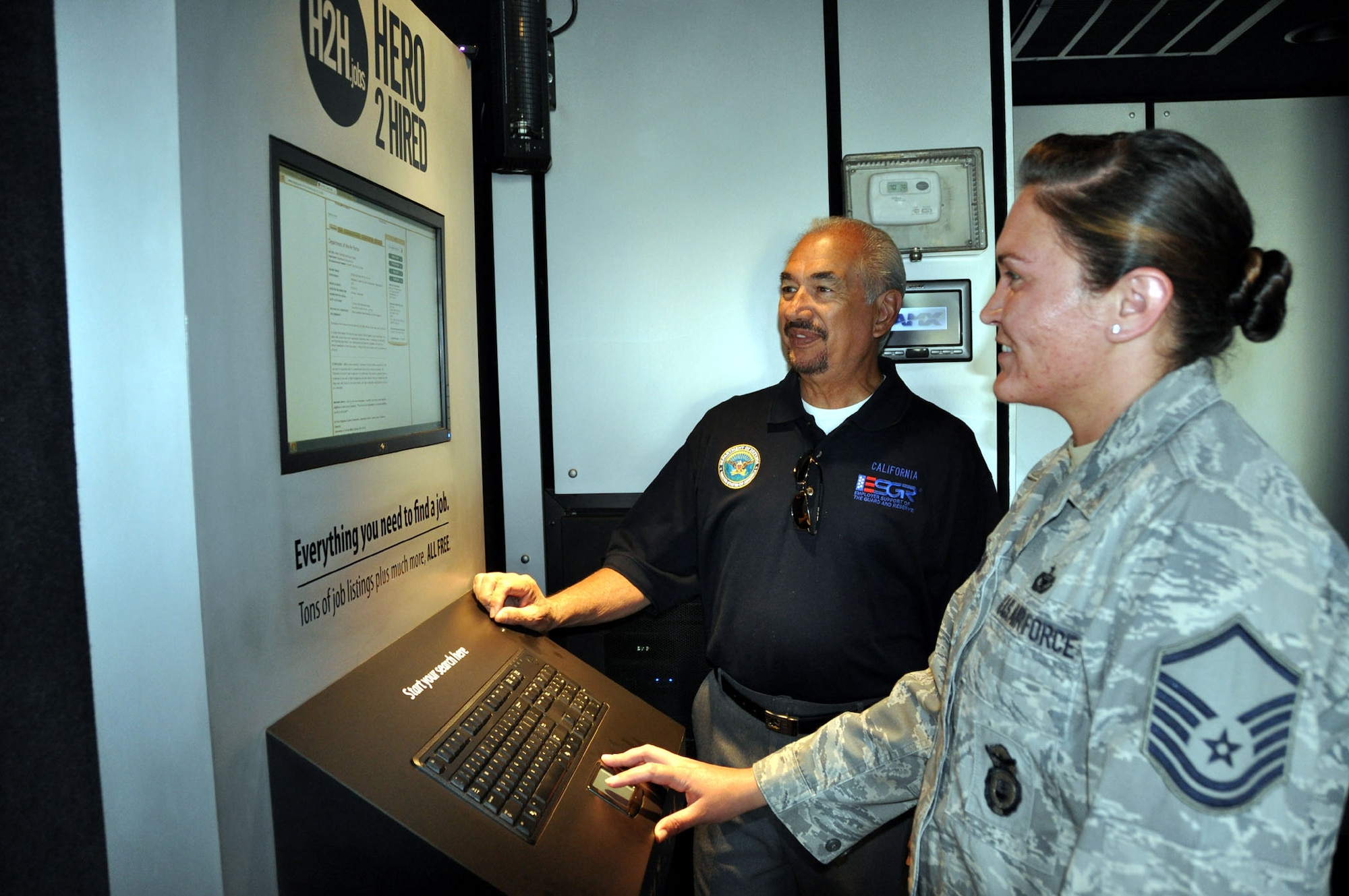 TRAVIS AIR FORCE BASE, Calif. -- Master Sgt. Sarah Felton, a full-time student and Individual Mobilization Augmentee for the 60th Security Forces Squadron, visits the Hero2Hired mobile center September 4, 2012, during its two-day stop at Travis Air Force Base, Calif. Carlos Trevino, an ESGR volunteer, was on-site to help her look up open job listings in her career field, explore education and training resources, and view networking opportunities. Felton is currently using the Post 9/11 GI bill but will be looking for a job when she graduates in the next six months. (U.S. Air Force photo/Maj Torri Crosby)