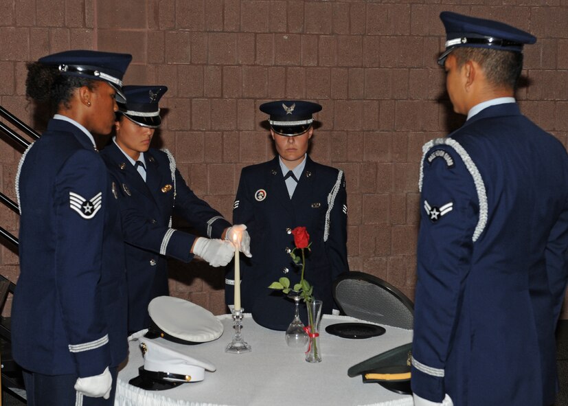 A Dyess Honor Guardsman lights the ceremonial Prisoner of War Missing in Action Candle during the annual Air Force Ball Sept. 14, 2012, at the Civic Center in Abilene, Texas. Dyess celebrated the Air Force’s 65th anniversary with the Air Force Ball. (U.S. Air Force photo by Airman 1st Class Peter Thompson/ Released)