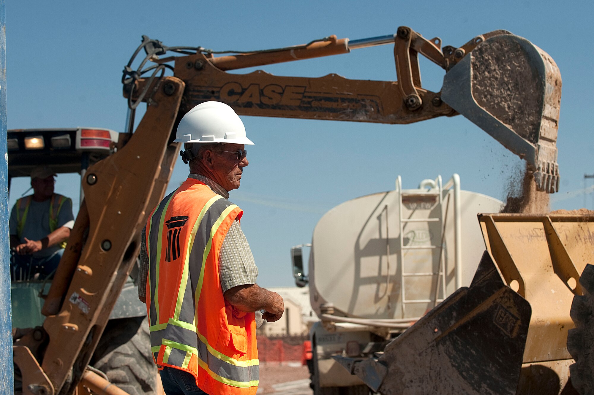 George Canapa, N.D. Excavating Co. superintendent, oversees construction operations on Tyndall Avenue Sept. 17, 2012, at Nellis Air Force Base, Nev. A small segment of Tyndall Avenue will be closed for construction from Sept. 17 through Oct. 5. Members of the N.D. Excavating Co. work to get all utilities into the new hangar. (U.S. Air Force photo by Staff Sgt. Christopher Hubenthal)