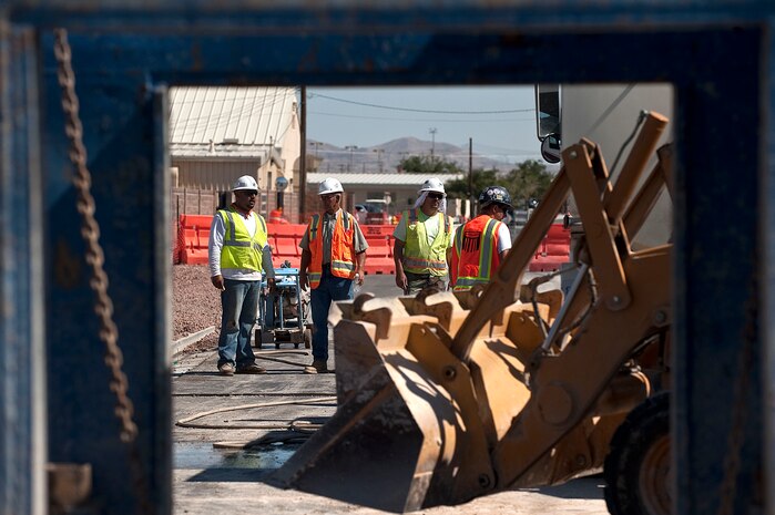 Members of the N.D. Excavating Co., conduct construction operations on Tyndall Avenue Sept. 17, 2012, at Nellis Air Force Base, Nev. A small segment of Tyndall Avenue will be closed for construction from Sept. 17 through Oct. 5. Members of the N.D. Excavating Co. are working to get all utilities onto the property. (U.S. Air Force photo by Staff Sgt. Christopher Hubenthal)