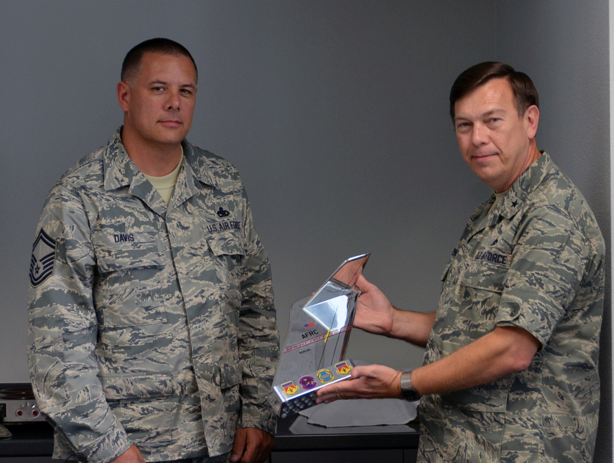 WRIGHT-PATTERSON AIR FORCE BASE, Ohio – Senior Master Sgt. Robert Davis, 445th Maintenance Squadron aircraft fabrication flight chief, presents Brig. Gen. Gary Blaszkiewicz, Director of Logistics, Headquarters Air Force Reserve Command, Robins Air Force Base, Ga., a tail flash plaque on behalf of the men and women of the 445th Airlift Wing during the general’s visit to the wing Sept. 7-9. (U.S. Air Force photo/Lt. Col. Cynthia Harris)