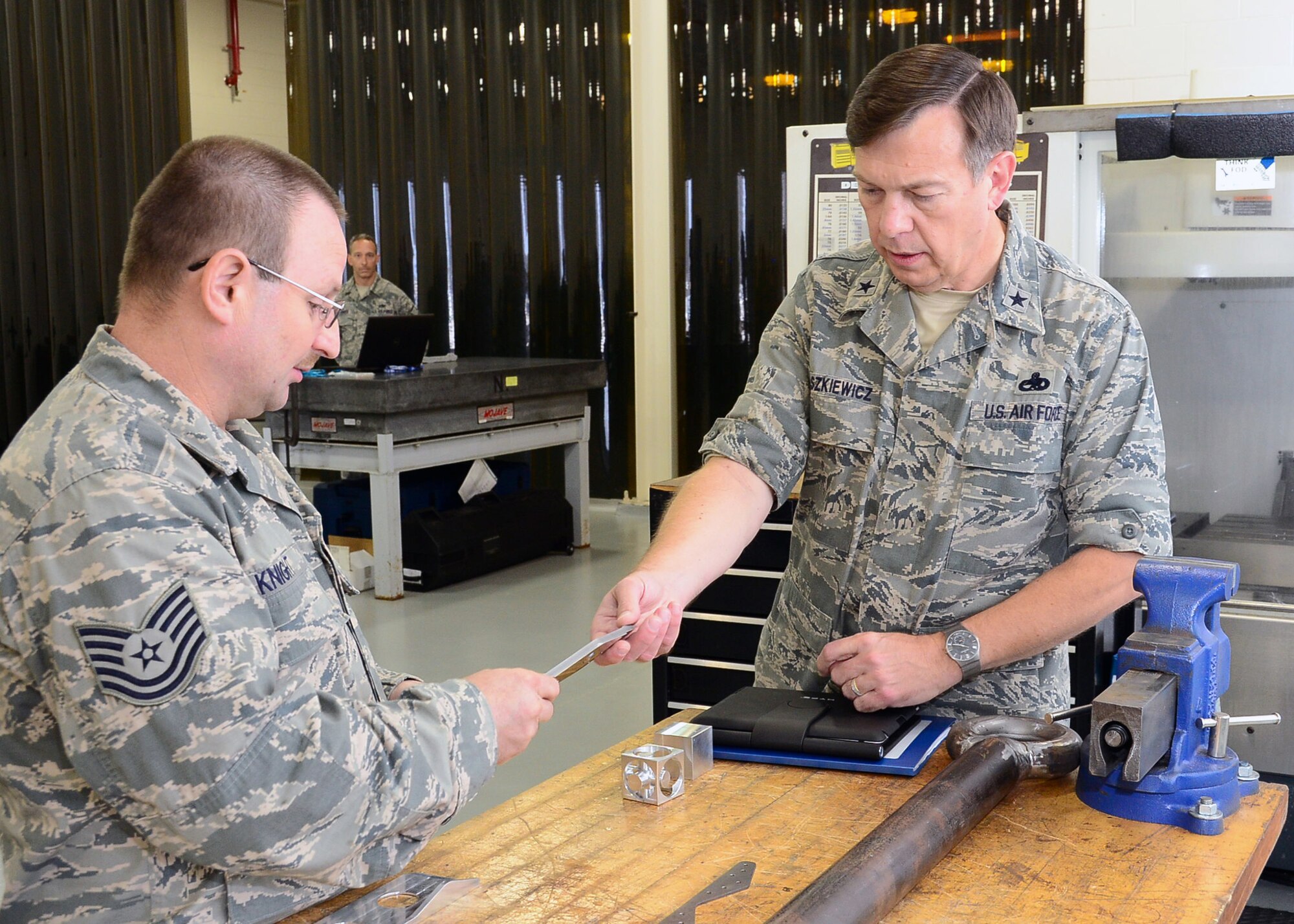 WRIGHT-PATTERSON AIR FORCE BASE, Ohio - Tech. Sgt. Timothy Knight, 445th Maintenance Squadron, aircraft metals technology, shows Brig. Gen. Gary Blaszkiewicz, Director of Logistics, Headquarters Air Force Reserve Command, Robins Air Force Base, Ga., a piece of sheet metal during the general’s tour of the fabrication flight Sept. 8. The general toured various 445th Airlift Wing units as part of his visit to Wright-Patt Sept. 7-9. (U.S. Air Force photo/Senior Airman Matthew Cook)