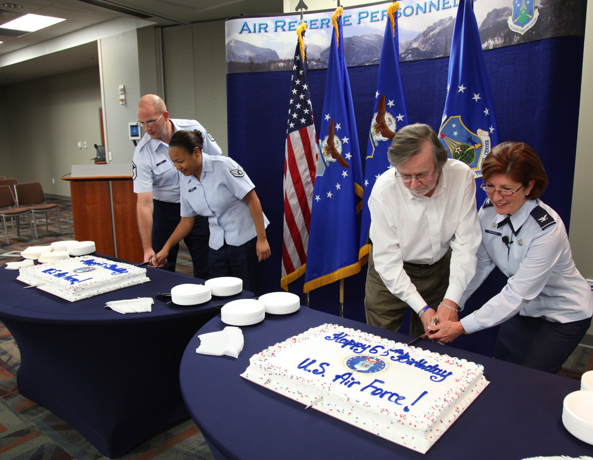 Col. Patricia Blassie, commander of Air Reserve Personnel Center, cuts a birthday cake with Mr. Jim Jenkins, civilian Airman; Staff Sgt. Alexis McCray, regular Air Force; and Master Sgt. Jeremy Bohn, Air National Guard; at ARPC here today. Each member represented a component of the Total Force Airman. Leaders at ARPC are committed to building a diverse center that reflects the best of our nation dedicated to serving generations of Airmen. (U.S. Air Force photo by Mr. Quinn Jacobson) 
