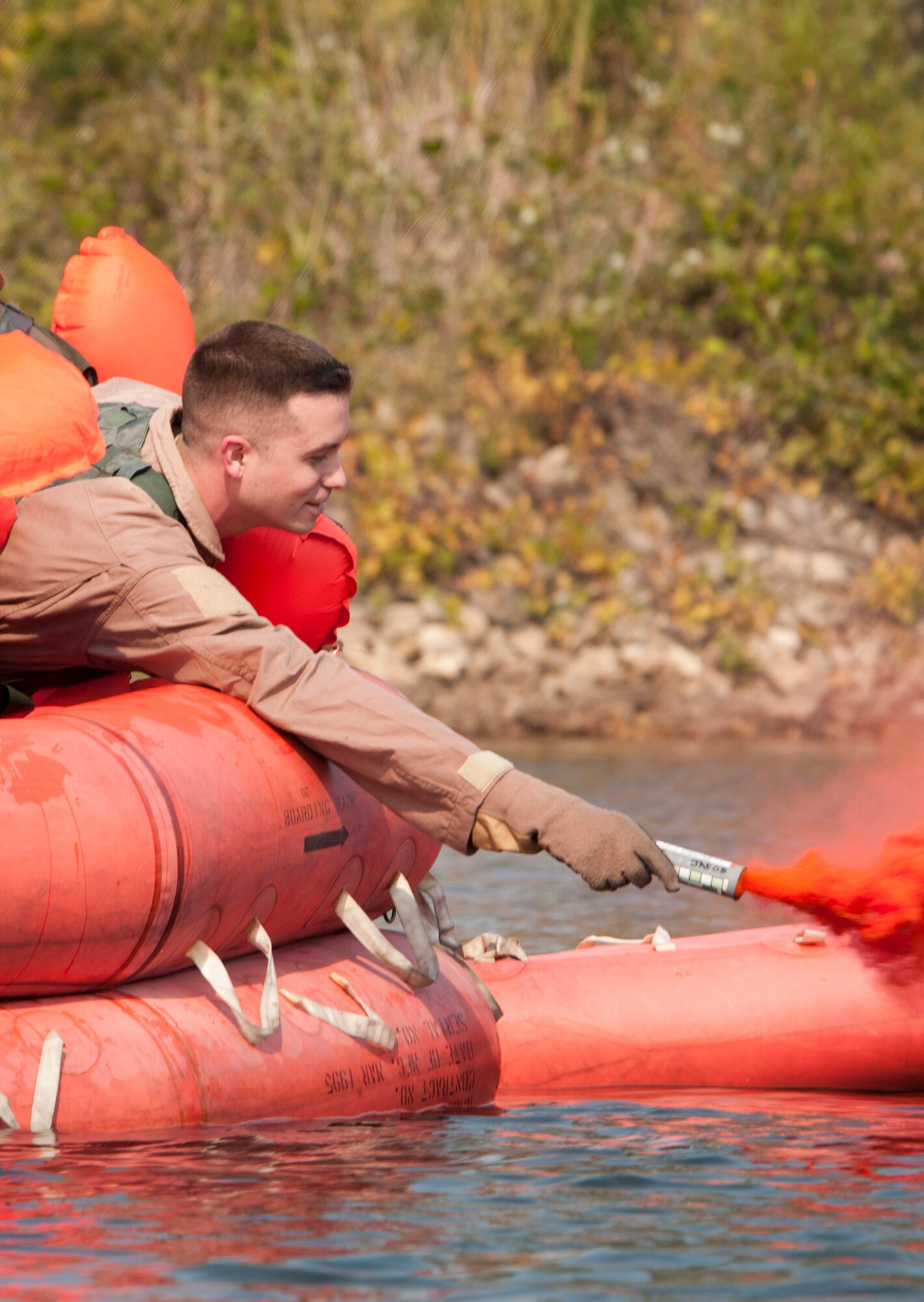 Staff Sgt. Travis Shore 109th Aeromedical Evacuation Squadron holds a signal flare from a raft during water survival training at the Army Training Site Arden Hills, Minnesota Sept. 16, 2012. . The Airmen of the 133rd Airlift Wing, Minnesota Air National Guard are taking part in their annual survival including survival equipment, lift raft familiarization, parachute disentanglement and rescue techniques. 
U.S. Air Force photo by Tech. Sgt. Erik Gudmundson/released
