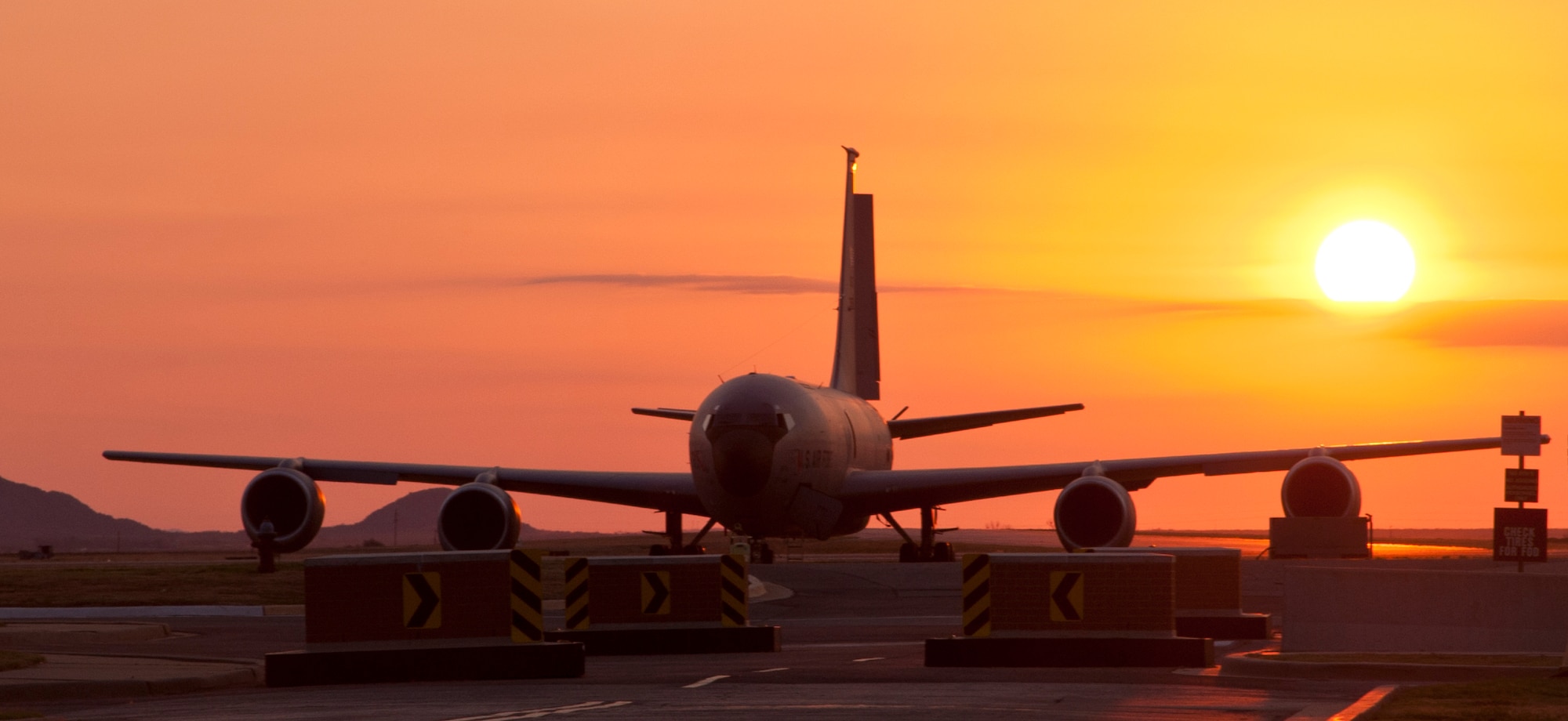 ALTUS AIR FORCE BASE, Okla. – The sun rises behind a KC-135 Stratotanker on the flight line Sept. 18, 2012. The mission at Altus AFB is to train KC-135 pilots and boom operators as well as C-17 Globemaster III pilots and loadmasters. (U.S. Air Force photo by Senior Airman Kenneth W. Norman / Released / 97th Air Mobility Wing Public Affairs)