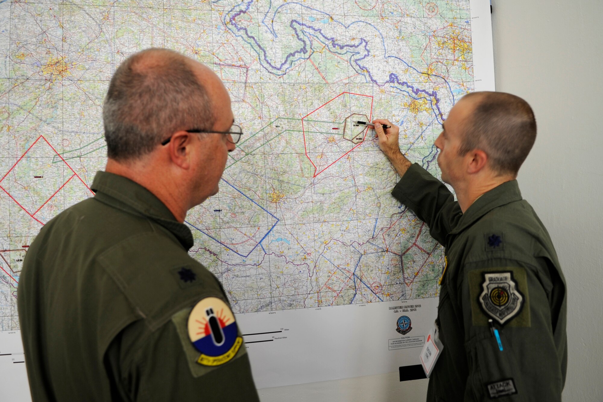Lt. Col. David Webb, the 307th Operations Support Flight commander discusses the B-52 Stratofortress’ role in the Ramstein Rover Exercise with Lt. Col. Steve Behmer, chief of the plans for the exercise Sept. 17, 2012. The exercise includes 21 countries and primarily trains Forward Air Controllers prior to deployment.  Two B-52s from Barksdale Air Force Base, La., are in Ostrava, Czech Republic for the annual NATO Days Air Show scheduled for Sept 22-23. This is the third year for the 307th Bomb Wing to support this air show. (U.S. Air Force photo by Senior Master Sgt Jessica Daurizio/Released)