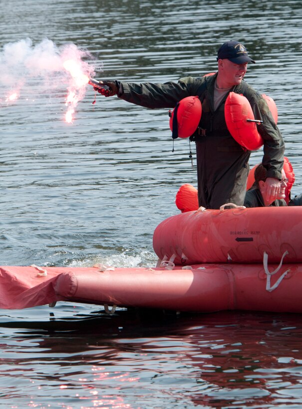 Lt. Col. Andrew Burda Commander 109th Airlift Squadron holds a signal flare aloft during water survival training tat the Army Training Site Arden Hills, Minnesota Sept. 16, 2012.. The Airmen of the 133rd Airlift Wing, Minnesota Air National Guard are taking part in their annual survival including survival equipment, lift raft familiarization, parachute disentanglement and rescue techniques. 
U.S. Air Force photo by Tech. Sgt. Erik Gudmundson/released
