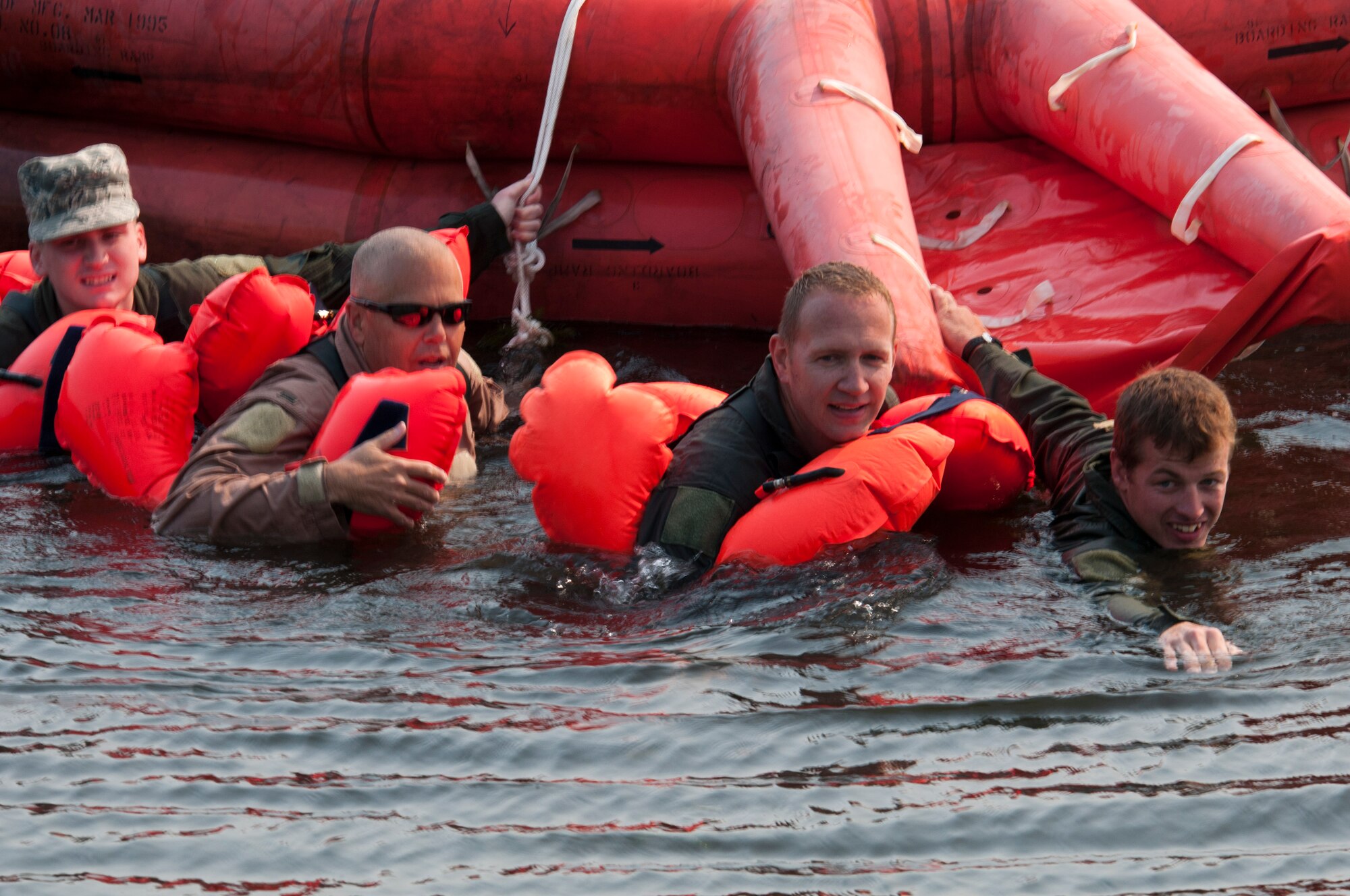 Airmen of the 133rd Airlift Wing are taking part in survival, evasion, resistance, and escape (SERE) training and water survival training including: lift raft familiarization, parachute disentanglement and rescue techniques.at the Army Training Site Arden Hills, Minnesota Sept. 16, 2012. Here a group of Airmen finsh the day by pulling the survival raft ashore. U.S. Air Force photo by Tech. Sgt. Erik Gudmundson/released