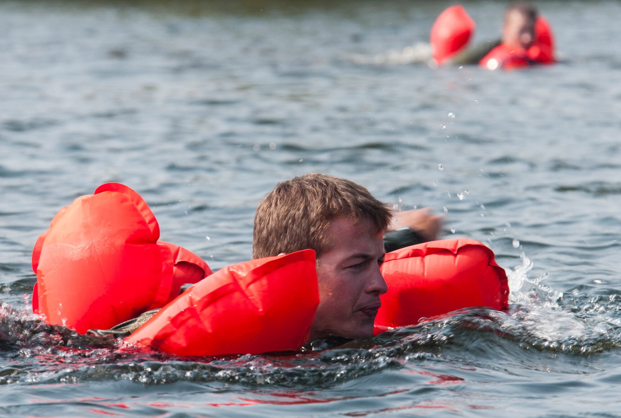 133rd Airlift Wing members swim in the waters of small lake at the Army Training Site Arden Hills, Minnesota Sept. 16, 2012 with their aircrew life preserver keeping them afloat. The Airmen of the 133rd Airlift Wing, Minnesota Air National Guard are taking part in their annual survival including survival equipment, lift raft familiarization, parachute disentanglement and rescue techniques. U.S. Air Force Photo by Tech. Sgt. Erik Gudmundson/released