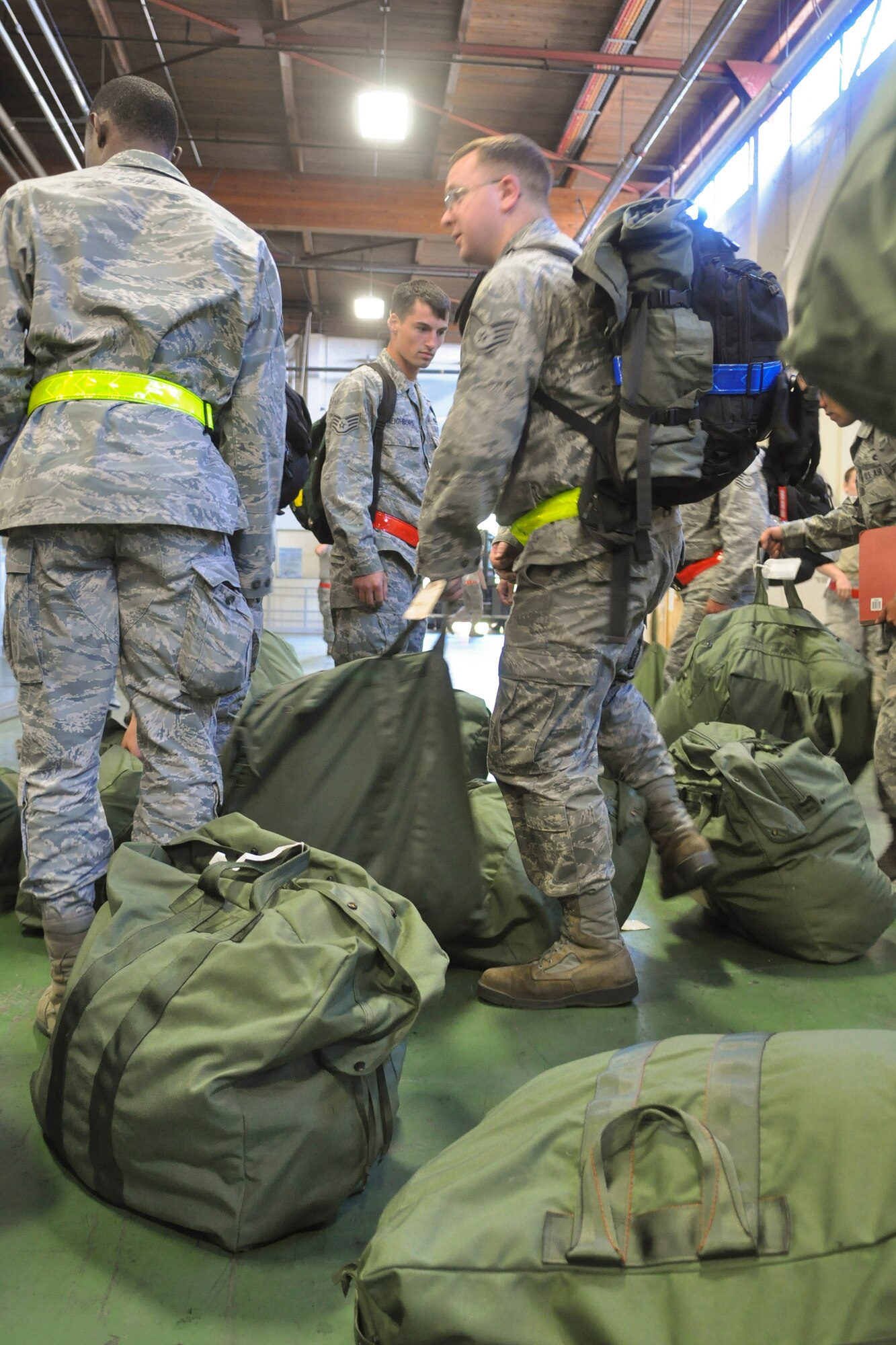 Airmen rush to retreive their bags upon return from an operational readiness exercise, Sept. 13, 2012 at Joint Base Lewis-McChord. The fly-away exercise took place at Volk Field, Wis., as a preperation for the upcoming operational readiness inspection.  (U.S. Air Force photo/Staff Sgt. Sean Tobin)