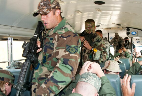 Members of the 133rd Airlift Wing are taking part in survival, evasion, resistance, and escape (SERE) training at the Army Training Site Arden Hills, Minnesota Sept. 16, 2012. Airmen of the 133rd Security Forces Squadron role playing the part of enemy captors storm a bus capturing members of the Wing during SERE training. U.S. Air Force photo by Tech. Sgt. Erik Gudmundson/released
