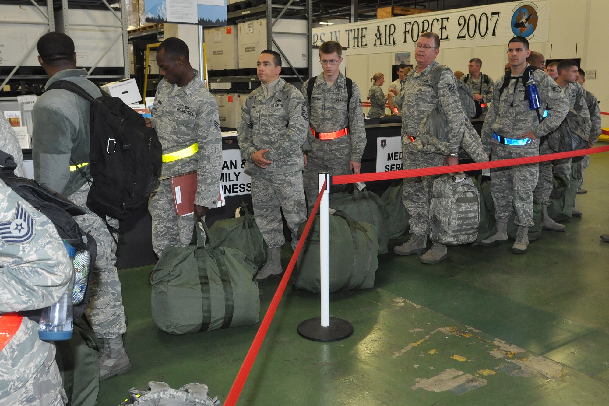 Airmen line up to process through the re-depolyment line upon return from an operational readiness exercise, Sept. 13, 2012 at Joint Base Lewis-McChord. The fly-away exercise took place at Volk Field, Wis., as a preperation for the upcoming operational readiness inspection.  (U.S. Air Force photo/Staff Sgt. Sean Tobin)
