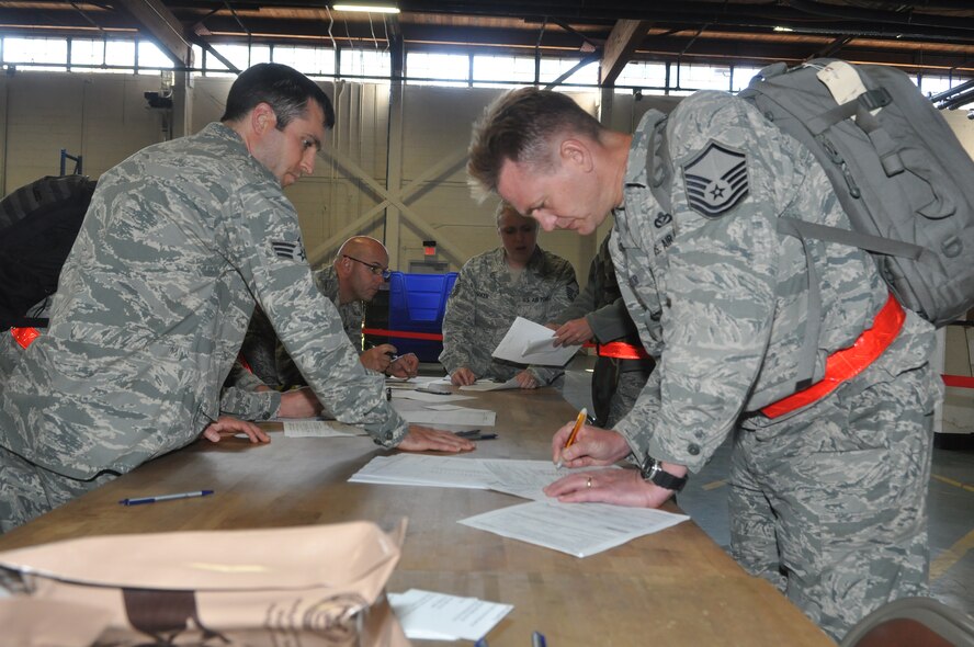 Airmen from the 446th Airlift Wing fill out financial paperwork Sept. 13, 2011, upon return to Joint Base Lewis-McChord, Wash. The Airmen were part of a fly-away operational readiness exercise at Volk Field, Wis. (U.S. Air Force photo/Staff Sgt. Sean Tobin)