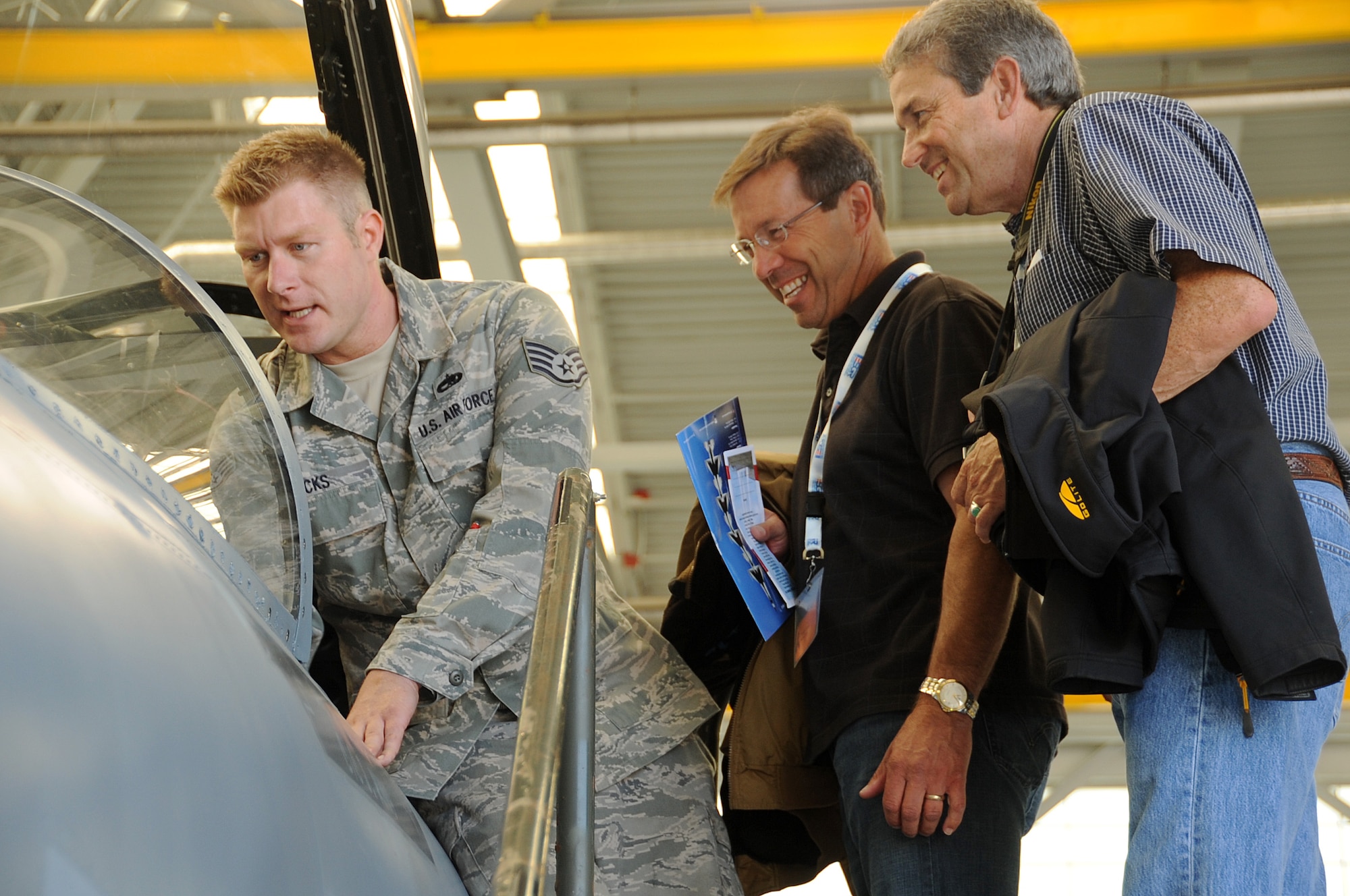 Oregon Air National Guard Staff Sgt. Nicholas Hicks answers questions from (from left to right) Todd Hess and Jim Linkous, both from Portland, Ore., about the F-15 Eagle on display during ESGR day at the Portland Air National Guard Base, Portland, Ore., Aug. 3, 2012. (U.S. Air Force photo provided by Staff Sgt. Lincoln Lease, 142nd Fighter Wing Public Affairs)