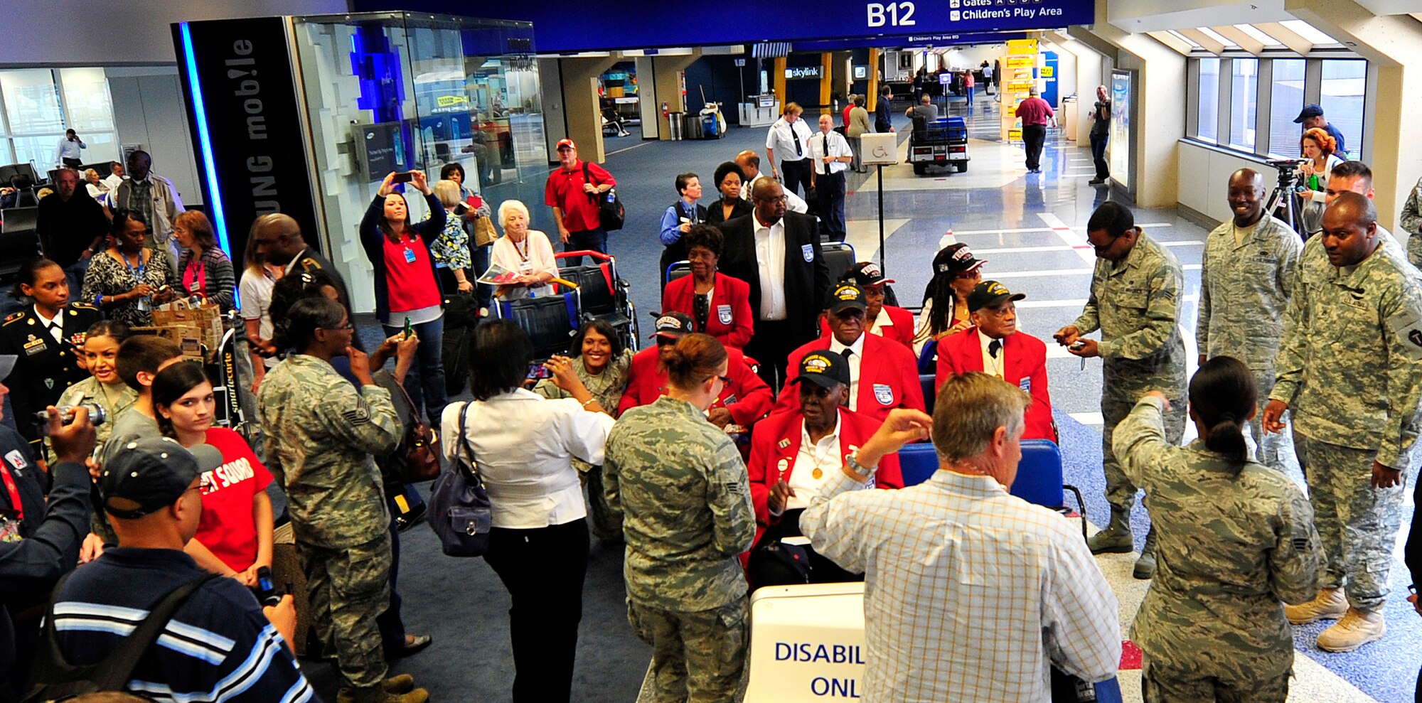 Four Tuskegee Airmen and their families made their way through DFW airport Sept. 14. Flight Officer Robert McDaniel, Capt. Claude Platte, Staff Sgt. Homer Hogues and Lt. Calvin Spann received a hero's farewell as they departed DFW for Montgomery, Ala., to attend "An Evening with the Red Tails" event at Tuskegee University. (U.S. Air Force photo/Senior Airman Martha Whipple)