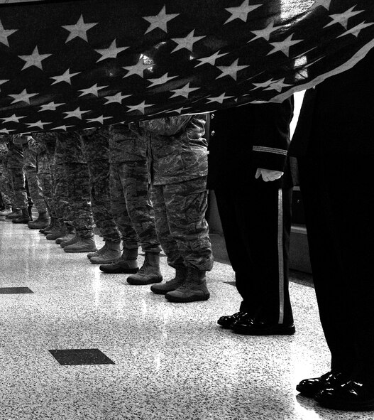 Members of the 301st Fighter Wing gathered at DFW airport Sept. 14, to form a "path of honor" for four Tuskegee Airmen who were traveling from Dallas to Montgomery, Ala., to attend "An Evening with the Red Tails" event at Tuskegee University. (U.S. Air Force photo/Senior Airman Martha Whipple)