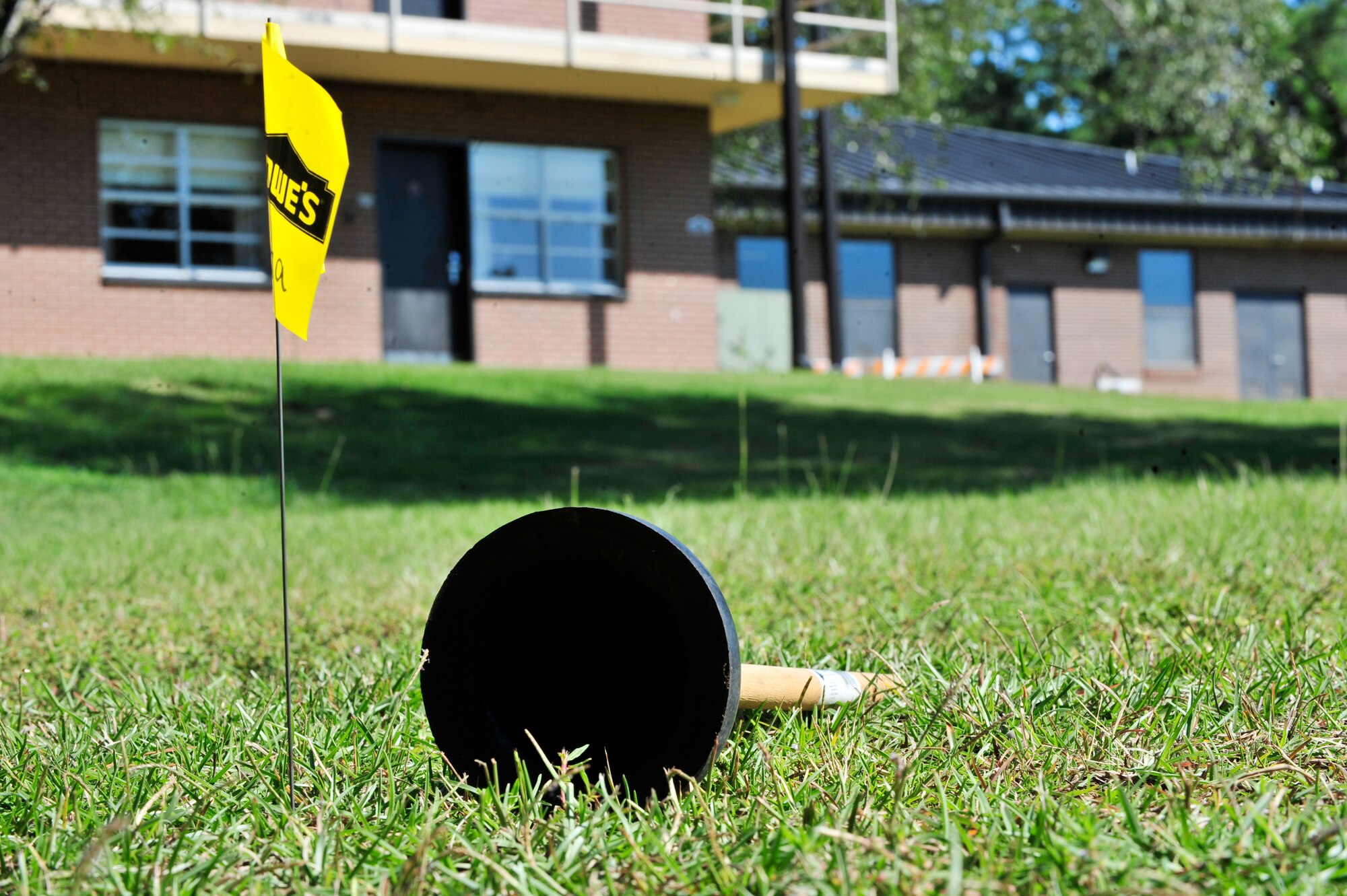 A plunger lies on the ground after being thrown at the international housekeeping week plunger toss at Shaw Air Force Base, S.C., Sept. 10, 2012. Carolina Pines Inn held this event to show appreciation for their staff.  Throughout the week, Carolina Pines housekeepers played games and competed for prizes.(U.S. Air Force photo by Airman Nicole Sikorski/Released)