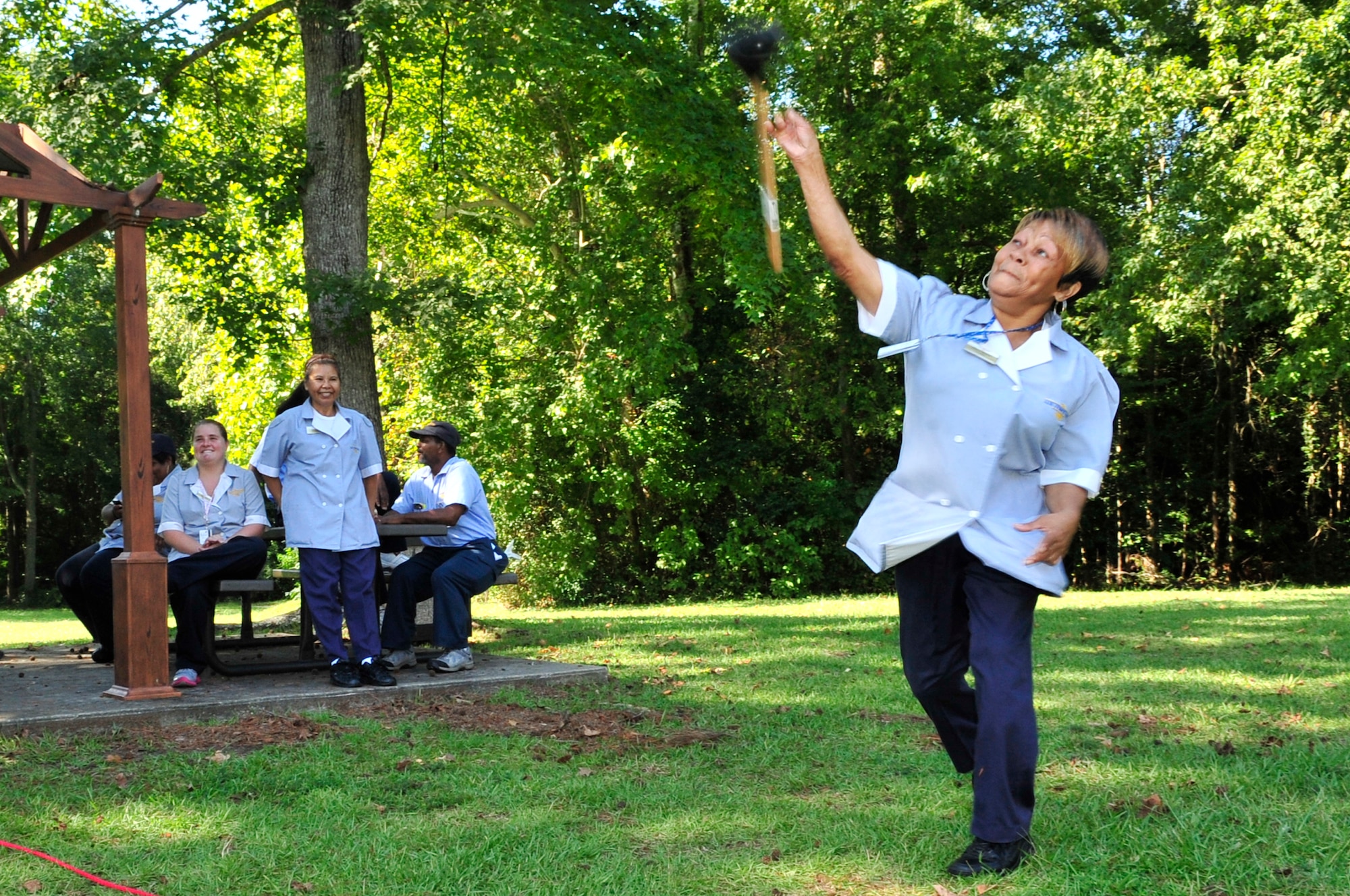 The housekeeping staff at Carolina Pines Inn participate in a plunger toss at Shaw Air Force Base, S.C., Sept. 10, 2012. Carolina Pines celebrated an international housekeeping week to show appreciation for their staff.  Throughout the week, Carolina Pines housekeepers played games and competed for prizes.(U.S. Air Force photo by Airman Nicole Sikorski/Released)