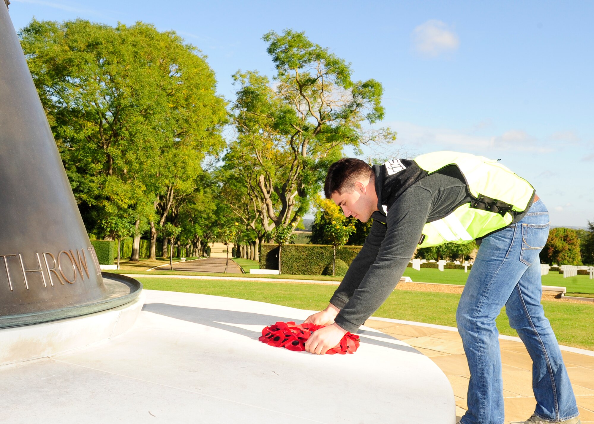 RAF MILDENHALL, England – Airman Keefer Patterson, 100th Maintenance Group, lays a wreath at Madingley American Cemetery in Cambridge Sept. 18, 2012. Keefer was one of the riders participating in the joint RAF Mildenhall and RAF Lakenheath Rolling Thunder motorcycle rally, who went to eight locations including Mildenhall, Newmarket, Bury St. Edmunds, Lakenheath, Diss and Mundford to honor those still unaccounted for by placing wreathes at various memorials and cemeteries. (U.S. Air Force photo/Senior Airman Ethan Morgan) 