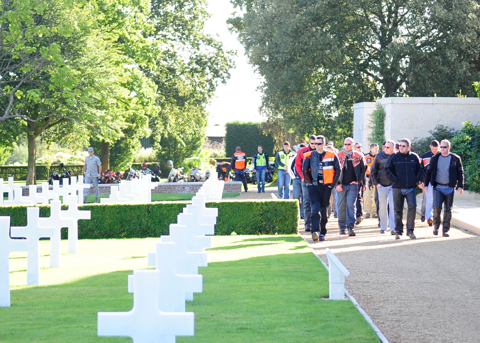 RAF MILDENHALL, England – Participants of the joint RAF Mildenhall and RAF Lakenheath Rolling Thunder motorcycle rally walk through Madingley American Cemetery in Cambridge Sept. 18, 2012, prior to laying a wreath. The riders went to eight locations including Mildenhall, Newmarket, Bury St. Edmunds, Lakenheath, Diss and Mundford to honor those still unaccounted for by placing wreathes at various memorials and cemeteries. (U.S. Air Force photo/Senior Airman Ethan Morgan) 